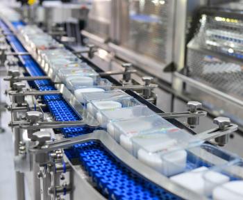 Food products being transferred automatically on an automated conveyor system.